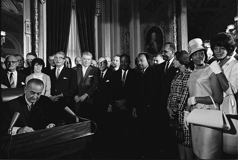 President Lyndon B. Johnson signs the Voting Rights Act of 1965 while Martin Luther King and others look on President Lyndon B. Johnson signs the Voting Rights Act of 1965 while Martin Luther King and others look on